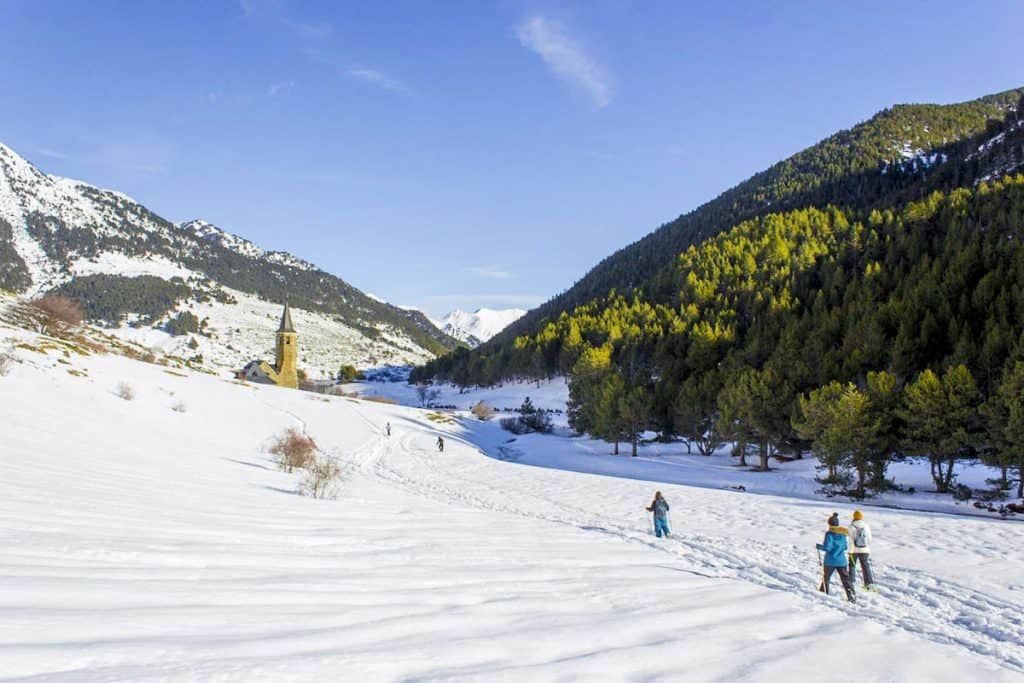 Three people snowshoeing to Montgarri