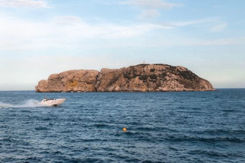 A boat passing in front of the Medes Islands